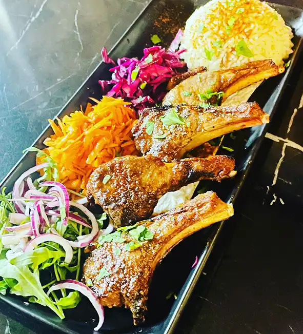 Char-grilled lamb chops served with rice and salad